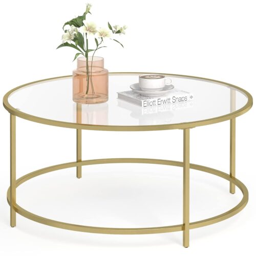 Runder Couchtisch aus Glas mit goldenem Metallrahmen, auf dem eine Vase mit Blumen, eine Tasse und eine Untertasse sowie ein Buch stehen.